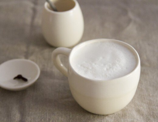 coffee with frothed milk in a white mug